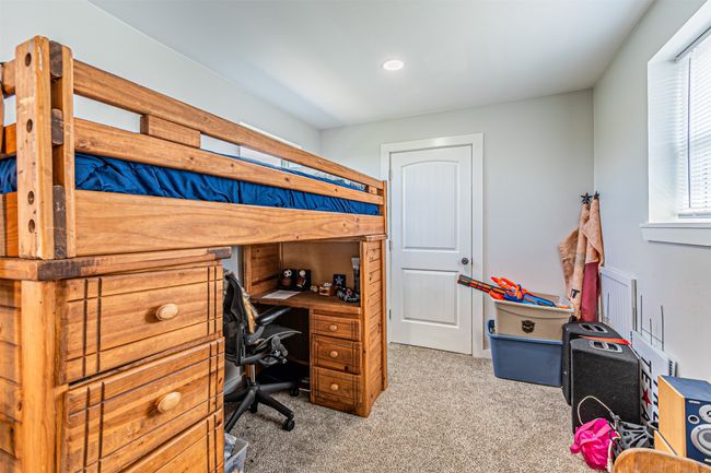Bedroom with carpet flooring, recessed lighting, and an office area | Image 32