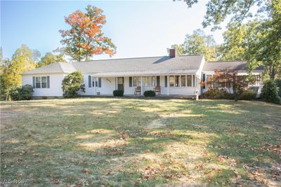 Single story home featuring a front lawn and a porch | Image 1