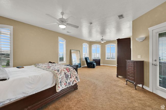 Bedroom featuring light colored carpet, baseboards, and visible vents | Image 28