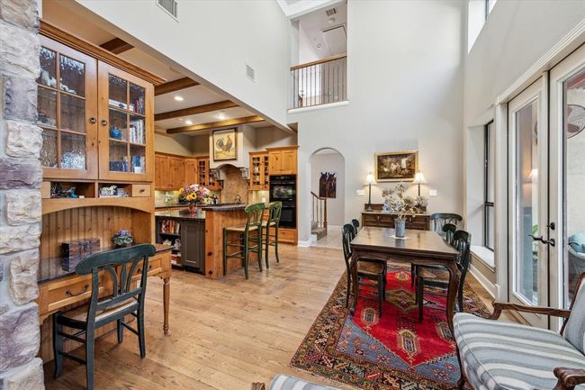 Nestled just behind the stone archway upon passage to the breakfast area is a phone desk, providing an area to keep daily mail and clutter contained and organized or from which to make your daily calls. All cabinetry in this home is custom crafted of the finest quality wood. Character is abundant throughout with architectural details and custom created hardware. | Image 14