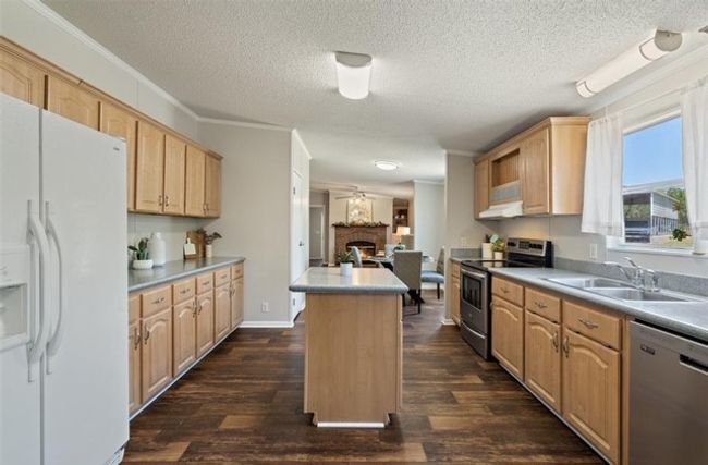 Galley style kitchen connected to the dining room and secondary living room | Image 21