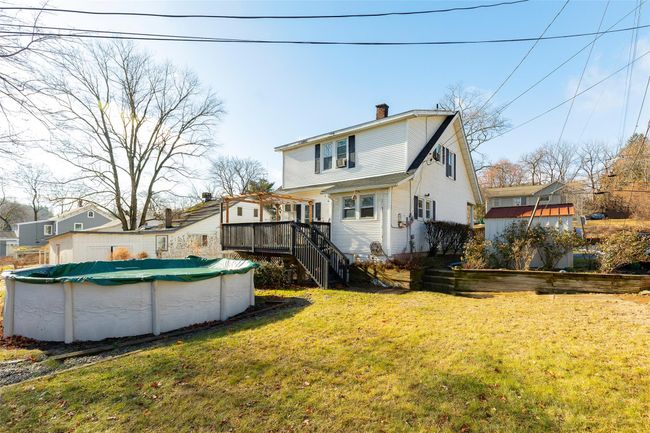 Rear view of property featuring a lawn and a swimming pool side deck | Image 16