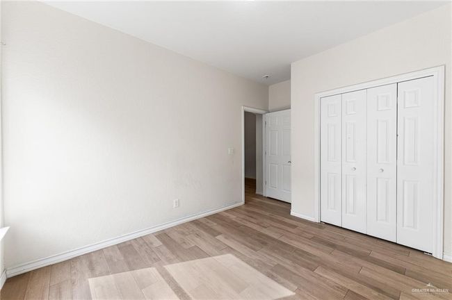 Unfurnished bedroom with light wood-type flooring and a closet | Image 28