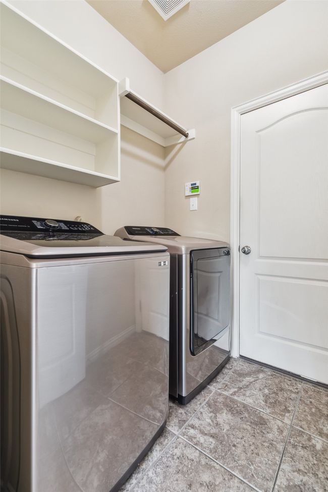 Laundry area featuring washer and dryer and baseboards | Image 22