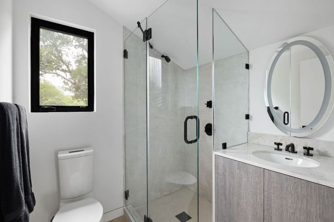 Bathroom featuring toilet, vanity, a shower stall, and vaulted ceiling | Image 26