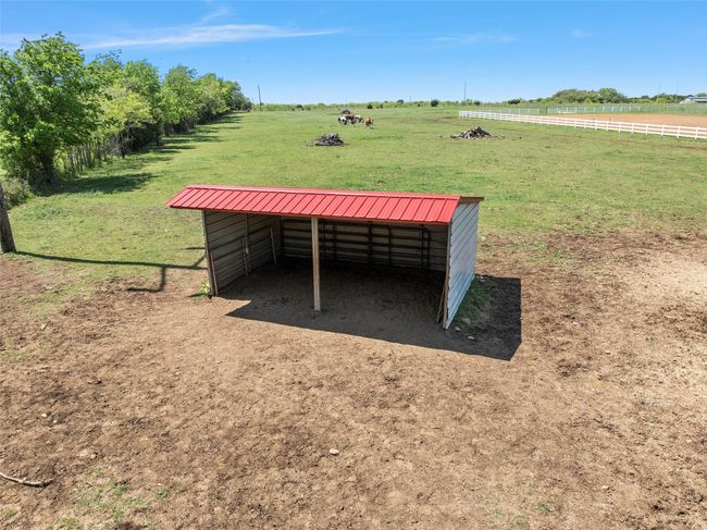 View of yard featuring an outdoor structure and a rural view | Image 36