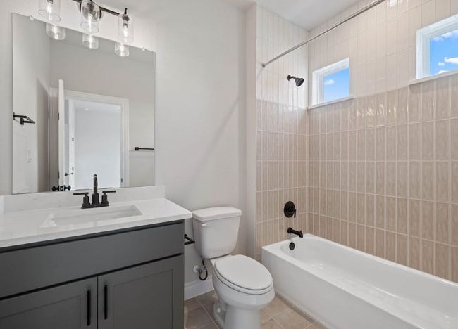 Bathroom featuring tile patterned floors, a healthy amount of sunlight, toilet, and shower / bathing tub combination | Image 26