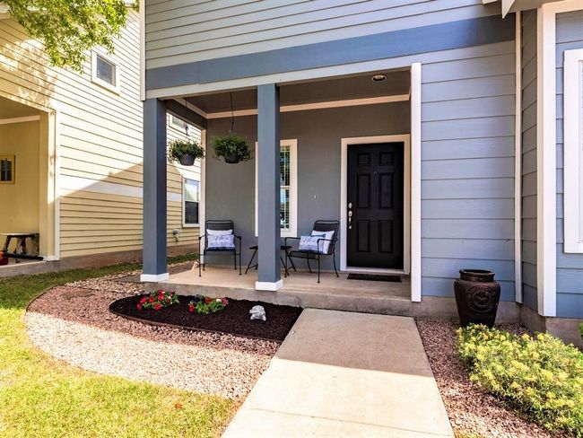 Featuring a welcoming covered front porch and charming landscaping. | Image 8