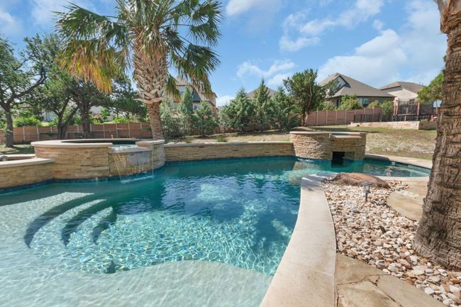 View of pool featuring a pool with connected hot tub and a fenced backyard | Image 35