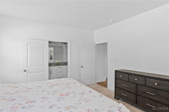 Bedroom featuring light colored carpet and baseboards | Image 18