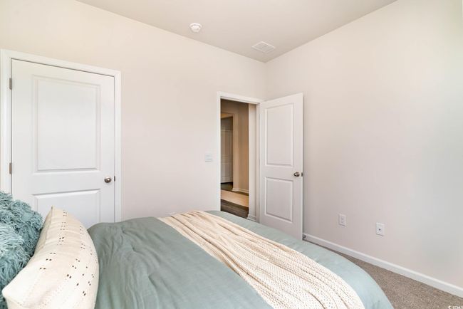 Carpeted bedroom featuring visible vents and baseboards | Image 18