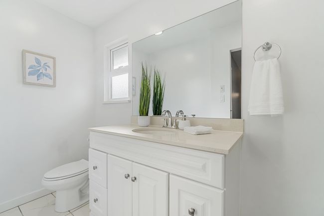 Half bath with marble finish floor, baseboards, vanity, and toilet | Image 26