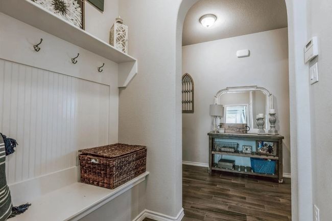 Mudroom featuring arched walkways, baseboards, and wood finished floors | Image 16