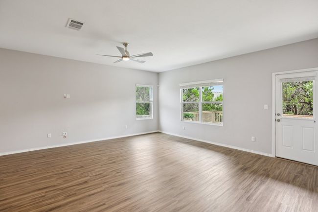 Windows overlooking the covered patio, deck and greenbelt. On the shady side of the home. | Image 7