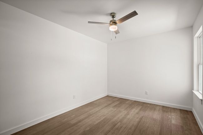 Spare room with wood finished floors, ceiling fan, and plenty of natural light | Image 14