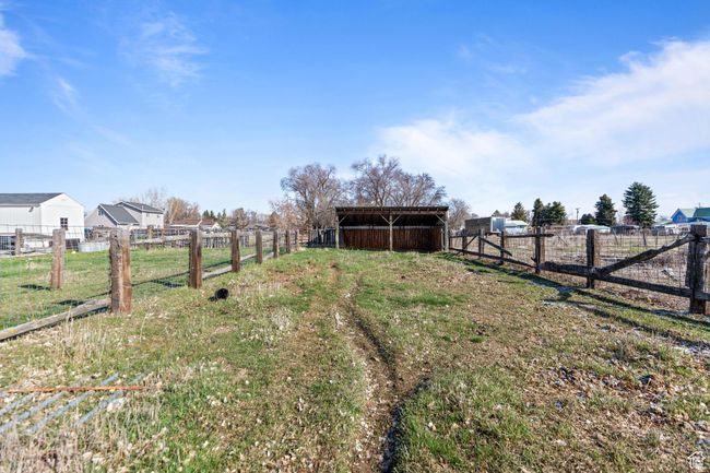 View of yard with an outbuilding, fence, a pole building, and a rural view | Image 6