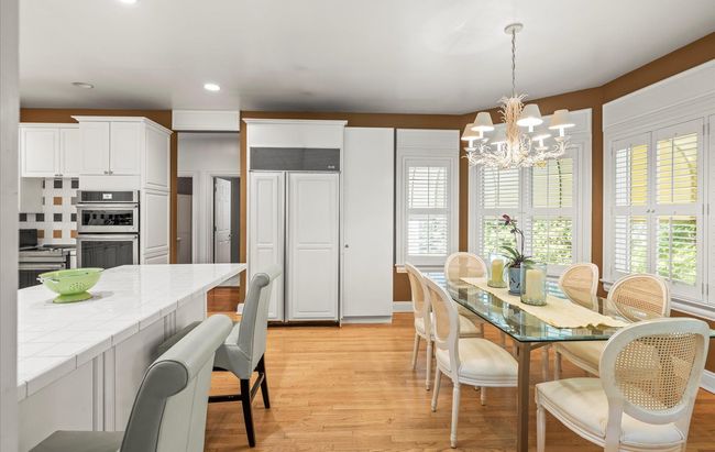 Dining area featuring light wood-style flooring, a chandelier, and recessed lighting | Image 13
