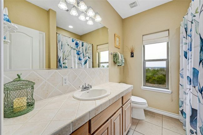 Clean and bright, this bathroom also offers a hill country view. | Image 20