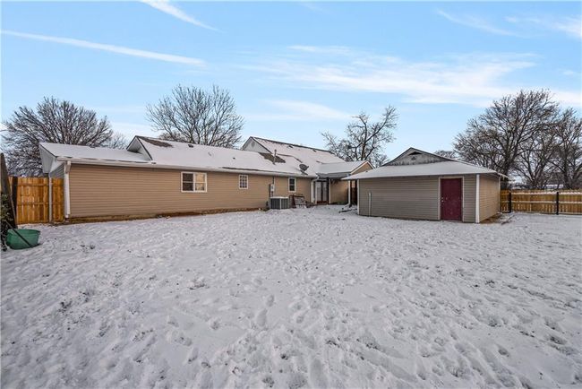 Back of property with a storage shed and central air condition unit | Image 52