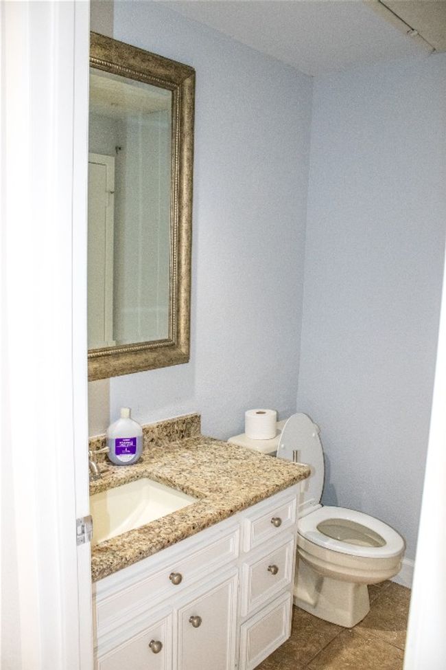 Bathroom with toilet, vanity, and tile patterned floors | Image 12