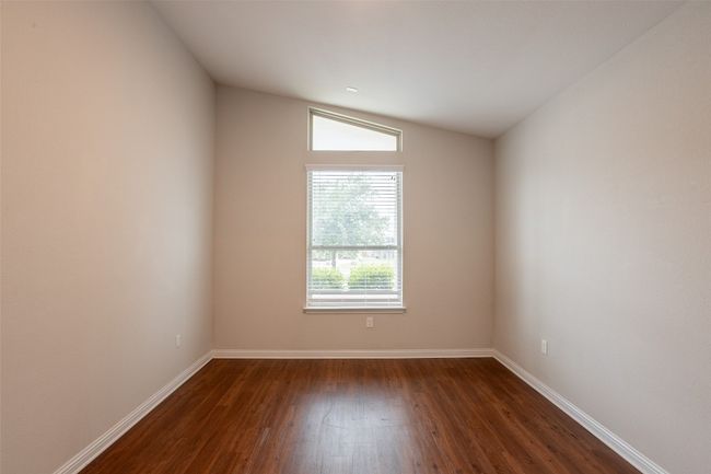 Empty room featuring baseboards and dark wood-type flooring | Image 11