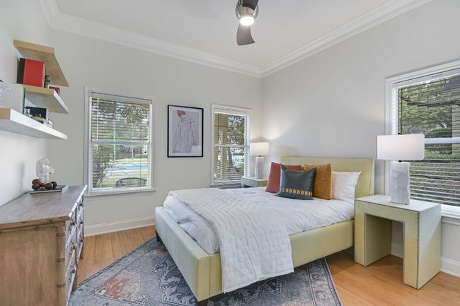 Guest bedroom on main level with built-in closet and attached full bathroom. | Image 13
