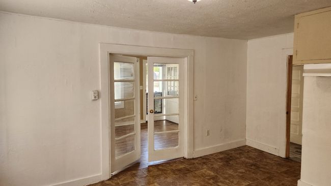 Unfurnished room with a textured ceiling and baseboards | Image 4