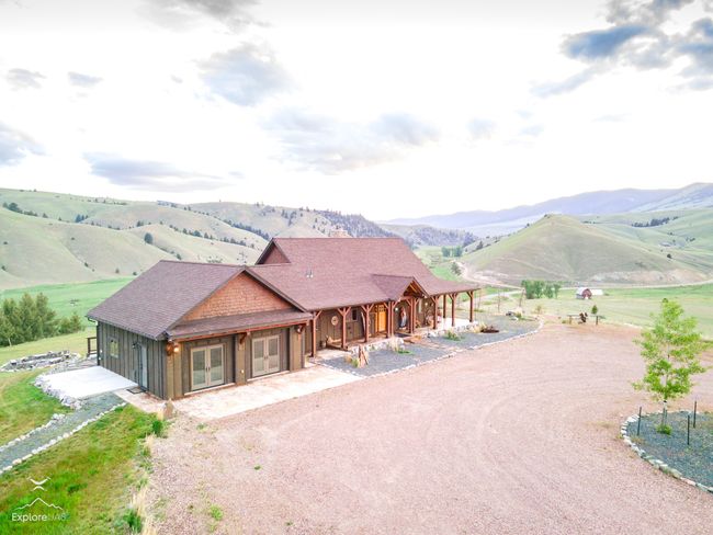 Chalet / cabin with dirt driveway, a porch, a mountain view, french doors, and roof with shingles | Image 33