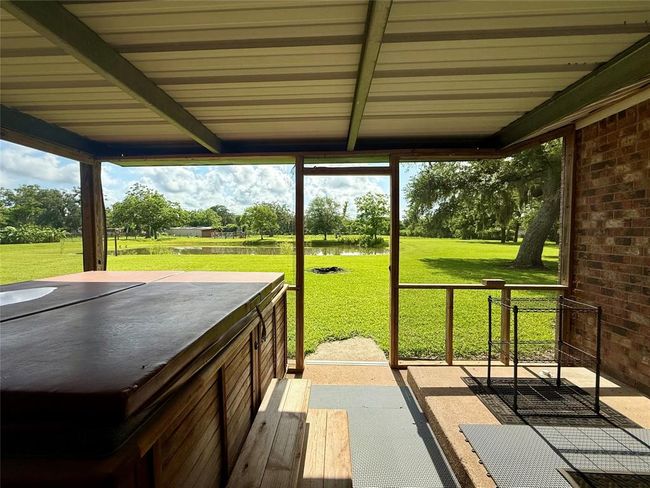Covered back porch with great views of property | Image 22