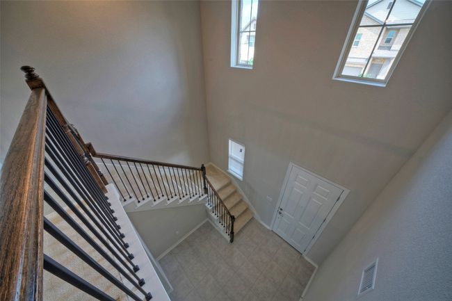 Staircase featuring baseboards and visible vents | Image 25