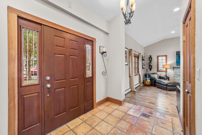 Side entrance. great for a mud-room, a healthy amount of sunlight, and vaulted ceiling | Image 18