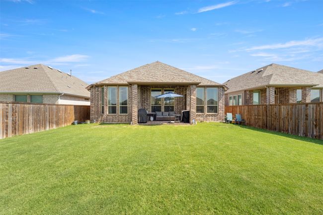 Rear view of house featuring a fenced backyard and brick siding | Image 29