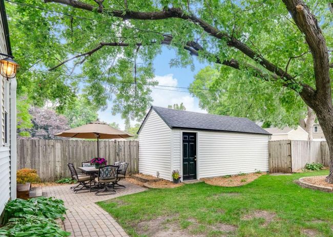 Full privacy fence around backyard with a gate to the front and another to the driveway | Image 32