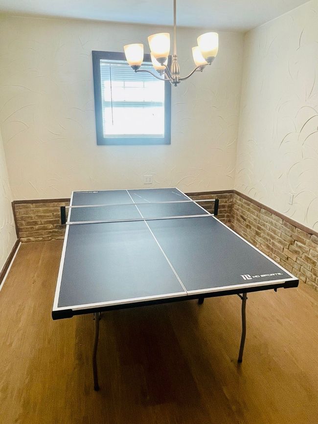 Playroom featuring wood finished floors and a chandelier | Image 22