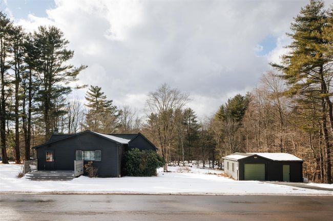 View of snow covered exterior with an outbuilding and a garage | Image 30