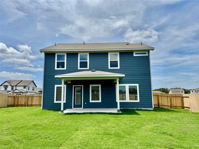 Rear view of house featuring a fenced backyard and a patio area | Image 5