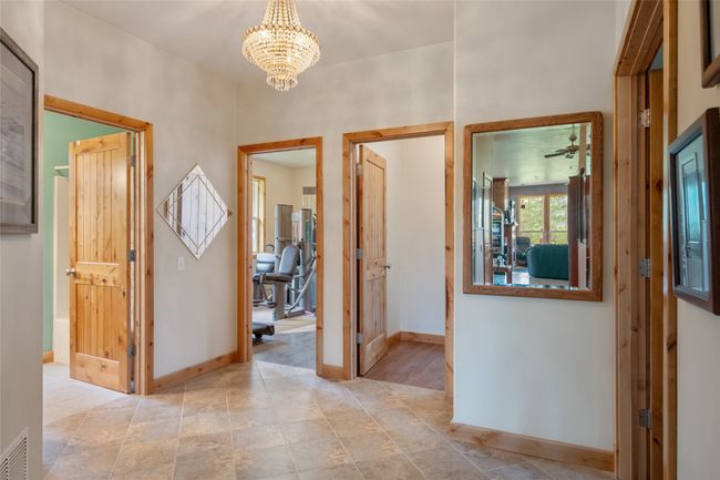 Hallway featuring a chandelier and baseboards | Image 52