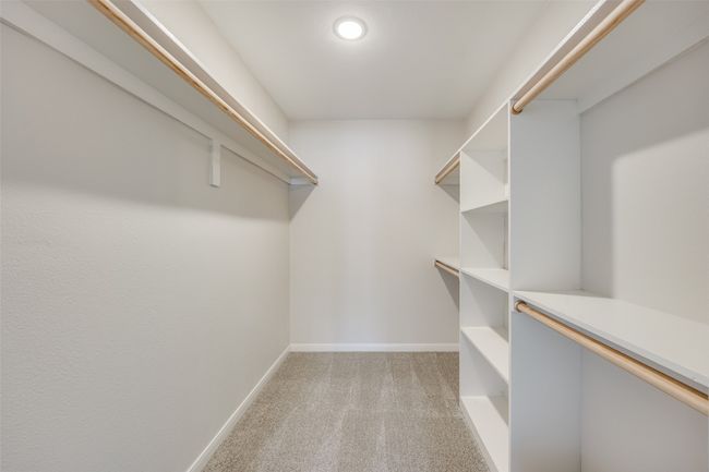 Spacious closet featuring light colored carpet | Image 25