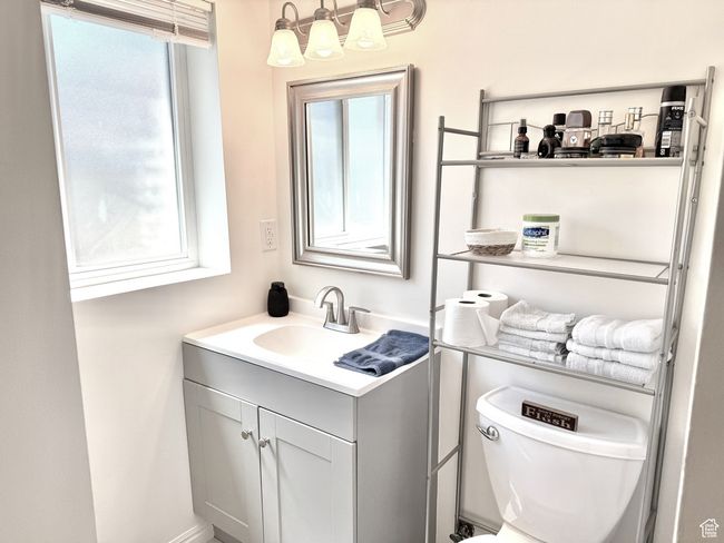 Half bath featuring vanity, toilet, and a shower stall. | Image 30