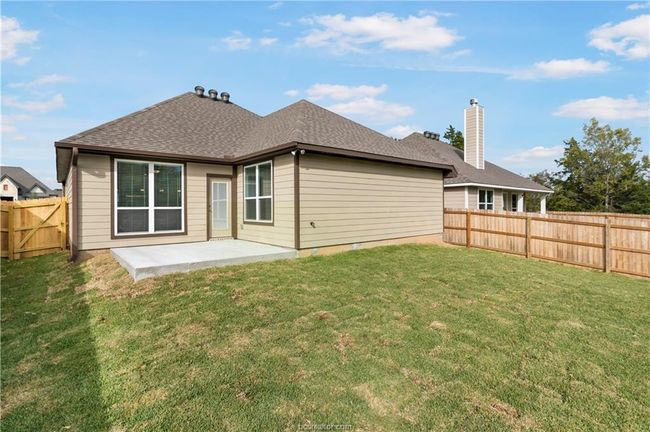 Rear view of property featuring a fenced backyard, a patio, a chimney, and roof with shingles | Image 20