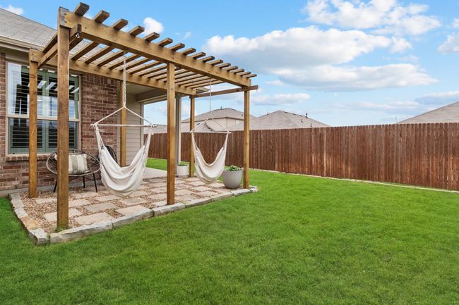 Fenced backyard featuring a pergola and a patio | Image 24