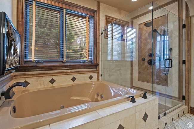 Bathroom with a shower stall and a bath | Image 36