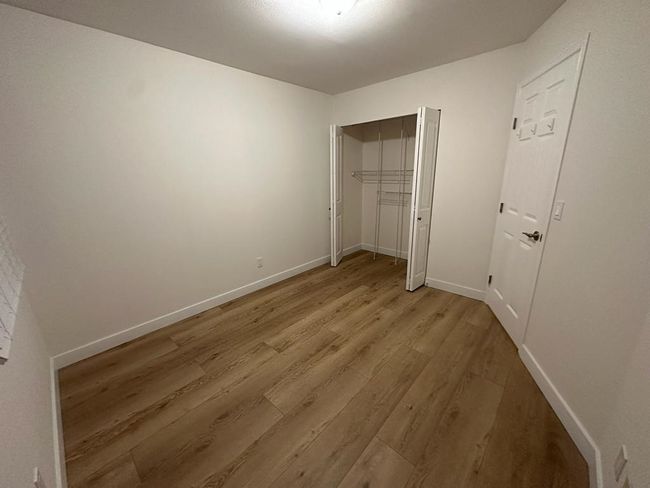 Unfurnished bedroom with a closet, light wood-style flooring, and baseboards | Image 9