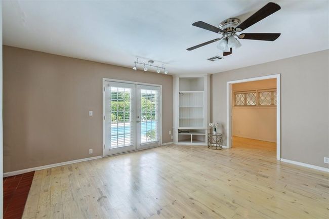 Spare room with french doors, a ceiling fan, and wood finished floors | Image 17