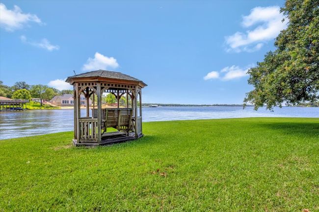 Dock featuring a gazebo, a water view, and a lawn | Image 7