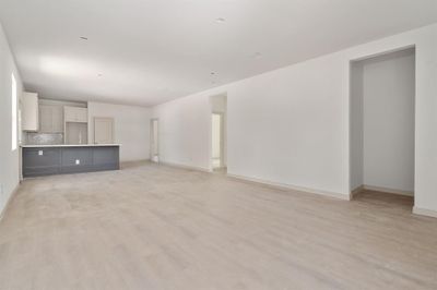 Unfurnished living room with light hardwood / wood-style flooring | Image 2