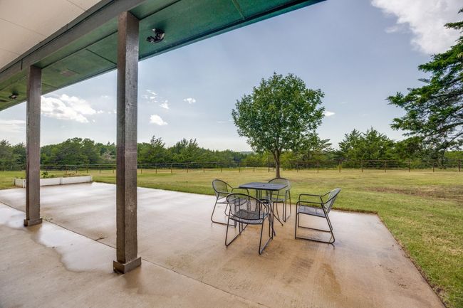 View of patio featuring outdoor dining space and view of scattered trees | Image 27