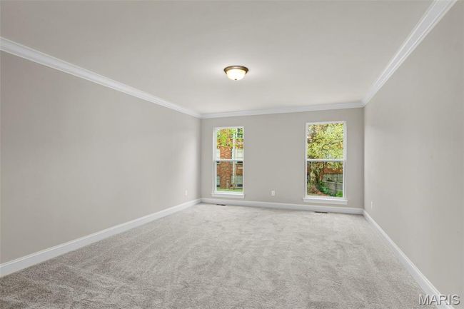 Carpeted spare room with crown molding and baseboards | Image 18