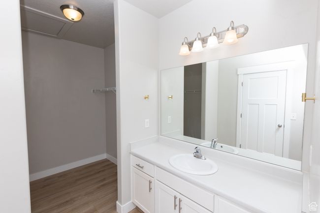 Bathroom with vanity, wood finished floors, and baseboards | Image 12
