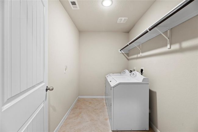 Experience convenience with the in-house utility room, thoughtfully designed with a dedicated laundry area. | Image 21